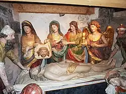 Jesus' body is prepared for burial. Jacques Lespagnol's moving "mise au tombeau" in the crypt of the Notre-Dame ossuary in Saint-Thégonnec