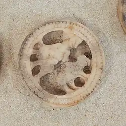 Seated figure with bear