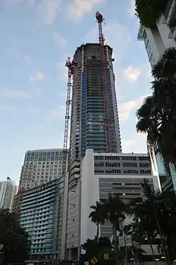 Panorama Tower under construction in October 2016 at about 60 floors with large multi-use pedestal (primarily parking) seen from Brickell Bay Drive