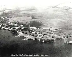 Aerial photo of shoreline buildings and docks