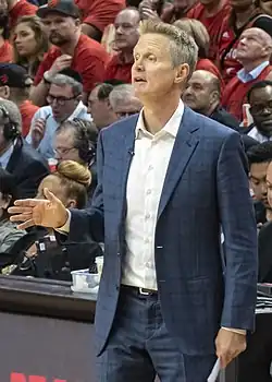 Steve Kerr, head coach of the Golden State Warriors and the highest paid coach in the NBA in 2025 standing near the scorer's table in Game 2 of the 2019 NBA Finals in Toronto.