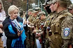 Robed woman, seated, with sword on her lap