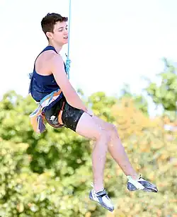 Toby Roberts suspended by a rope at the 2022 European Championships