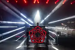 Carpenter Brut on stage with a band