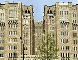 The top floors of a building with a grotesque on the edge