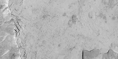 Close-up of blocks being formed, as seen by HiRISE under HiWish program as seen by HiRISE under HiWish program. Many long fractures are visible on the surface.
