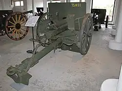 An Ehrhardt 7.5 cm Model 1901 with pole trail, spoked wooden wheels, gun shield and recoil spade. This is a typical WWI era, horse-drawn, direct fire, field gun.