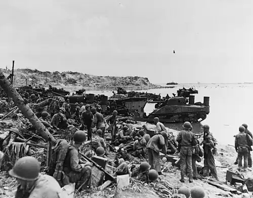 Asan Beach an hour and a half after the first landings. A field dressing station is in operation. Note LVTs and M-4 tanks.