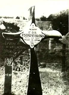Crucifix, made from an aeroplane propeller, in a cemetery. The inscription reads "Lt. Col. R.S. Dallas DSO DSC ... Killed in Action" 1 June 1918