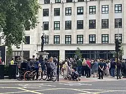 A crowd observing the statue