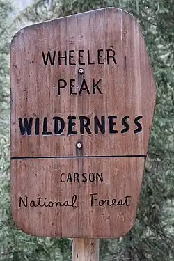 A wooden sign at the entrance of the Wheeler Peak Wilderness.
