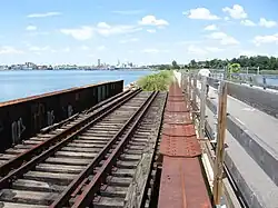 Abandoned rails still extant on a bridge adjacent to the bike path over Watchemoket Cove