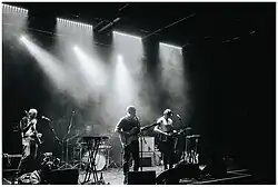 Adam Leonard (centre) playing with Invaderband in 2017.