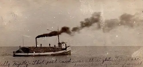 The steam barge Addie Wade outbound from Jacksonport with a cargo of logs; from a postcard postmarked in 1906
