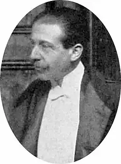 head and shoulders photograph of youngish middle-aged white man with neat moustache, wearing evening clothes