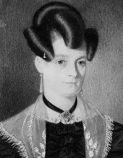 Photographic print of a painting of a woman with coiffed hair, wearing a formal black dress, satin (?) shawl, earrings and a necklace.