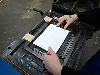 Laying a card directly onto the inked type (paper would normally be attached to the tympan by a frisket)
