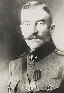 A black and white photograph of an older Estonian soldier, wearing a military uniform with a medallion.