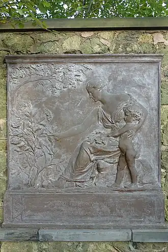Bronze tablet of a woman handing a plant to a young boy