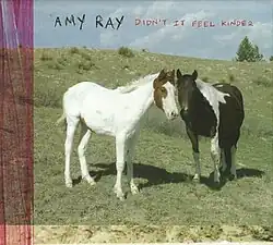 A photo of two horses in a field with the album named scrawled on top