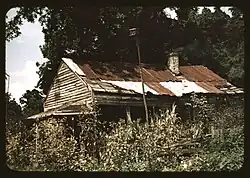 photograph of unpainted shack with tin roof