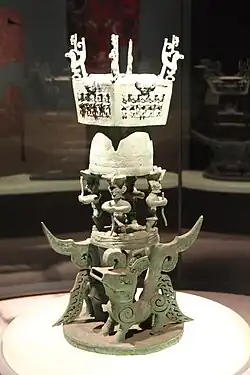 Tower featuring stylized human figures and mythical creatures