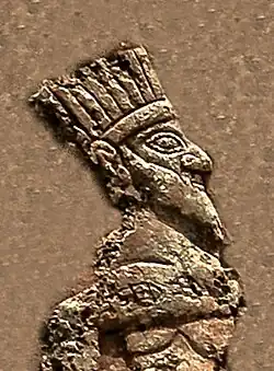 Prisoner king (detail). He appears to be wearing a crown.[15]
