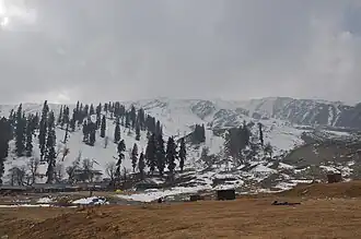 A large, snow-clad mountain ridge