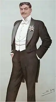 Spy caricature of white man standing, hands in pockets, with dark hair and slim moustache, wearing white tie and tails