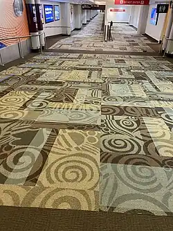 A hallway in 2021 within Nashville International Airport, carpeted entirely using the old design.