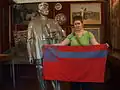A woman holding the flag of Soviet Georgia at the Batumi Stalin Museum.