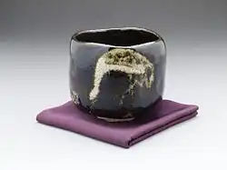 Black Raku teabowl "aged pine (shōrei) with crane design by Raku IX (Ryōnyū), Edo period, c. 1810–1838