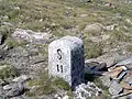Border stone at Passo San Giacomo between Val Formazza in Italy and Val Bedretto [it] in Switzerland