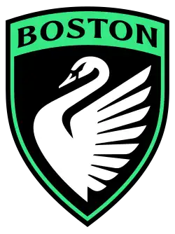 A black badge with a green outline, with an image of a white swan at center.