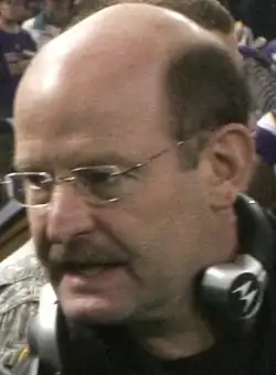 Brad Childress wearing glasses and a headset