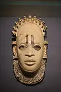 Pendant mask; by artists of the Edo people (Nigeria); 16th century (?); ivory and iron; height: 24.5 cm; British Museum, London[106]