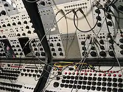 Earliest analog sequencers on Buchla 100 (array of knobs on the bottom)