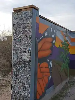 Mural on Mission Garden wall made of recycled plastic blocks