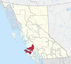 A map of British Columbia depicting its 29 regional districts and equivalent municipalities. One is highlighted in red.