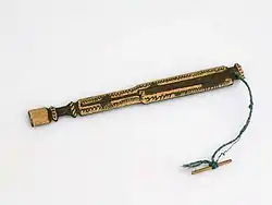 Photo of a genggong resting on a white surface