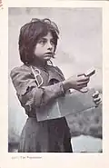 Young girl offering a box of matches for sale