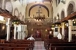 Interior with rows of columns and iconostasis in the Church of Saint Barbara