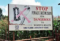 Campaign sign against female genital mutilation that reads:Stop Female Circumcision It is Dangerous to Women's Health
