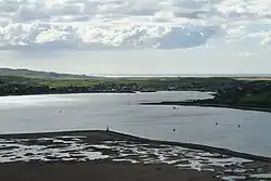 Campbeltown Loch and Campbeltown. Looking down from the top of Davaar. In the foreground is the Doirlinn, then the loch. On the western side of the loch is Campbeltown and beyond that Machrihanish Bay can be seen.