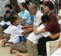 Image 39Display of respect of the younger towards the elder is a cornerstone value in Thailand. A family during the Buddhist ceremony for young men who are to be ordained as monks. (from Culture of Thailand)