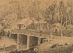 drawing of a wooden building with a water wheel behind a log bridge