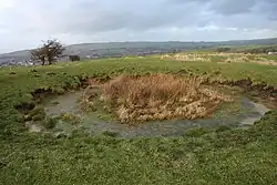One of the many bell pit circles on top of the fort
