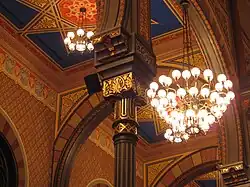 An arch and chandelier inside the synagogue