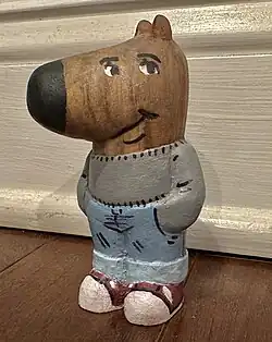 A three-dimensional painted carving of the character made out of wood