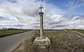 A Christian cross in border of a road